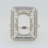 Sterling silver semi mount ring setting with halo of white topaz, designed for a 20x15mm emerald centerpiece.